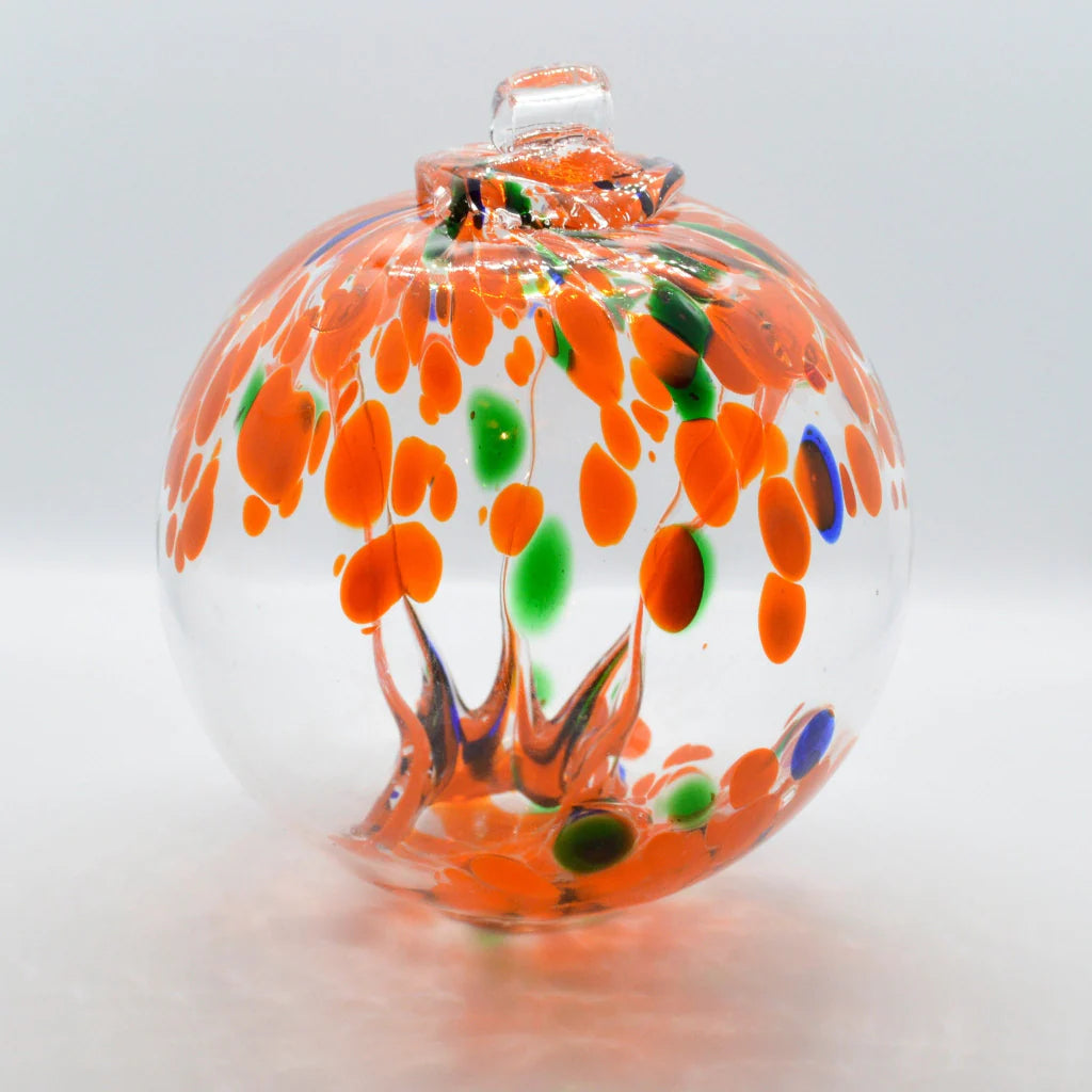 2 Sisters Artisan Glass 4 inch Hand blown glass witch ball ornament with orange, blue, and green with all the great energy. Blown glass tree of life suncatcher in orange green and blue.