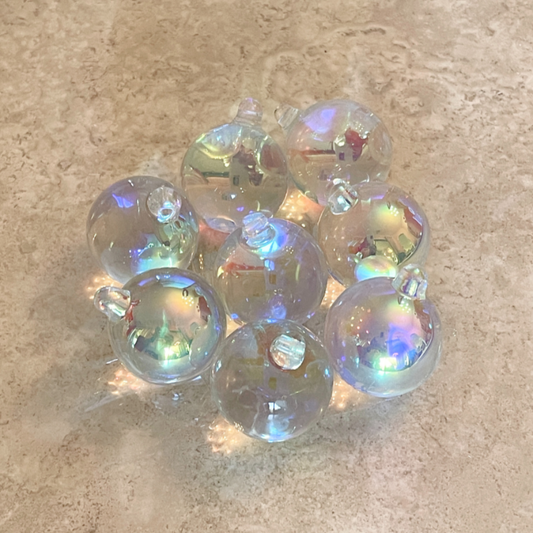 2 Sisters Artisan Glass Set of 8 iridescent clear glass balls. These glass baubles are stunning with a slight pinkish and blue cast when the light hits the iridescence. 